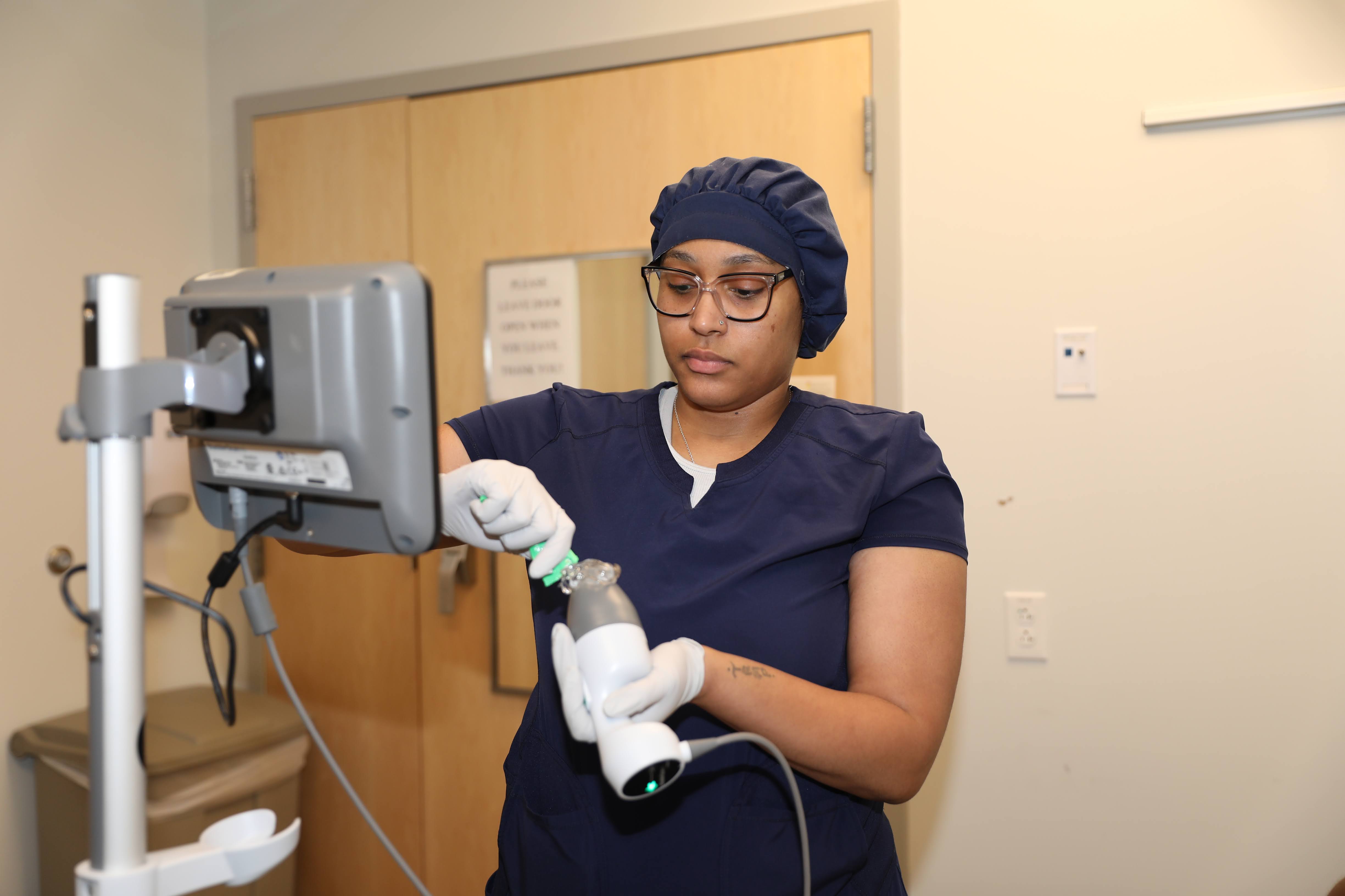 A resident works on a machine